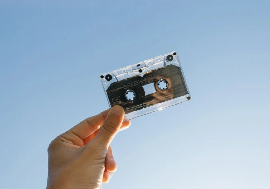 A person holding a cassette in the air